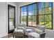 Bright sitting area with large windows overlooking the pool and landscaped backyard at 7713 Still Lakes Dr, Odessa, FL 33556