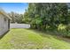 Large backyard featuring a well-maintained lawn and a privacy fence at 7725 Tangle Rush Dr, Gibsonton, FL 33534