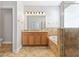 Bathroom featuring double sink vanity with granite counters, a soaking tub, and a glass-enclosed shower at 7725 Tangle Rush Dr, Gibsonton, FL 33534