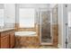 Bathroom featuring tiled shower, soaking tub, and vanity at 7725 Tangle Rush Dr, Gibsonton, FL 33534