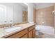 Bathroom featuring granite countertops, a sink, toilet, and tile bathtub at 7725 Tangle Rush Dr, Gibsonton, FL 33534