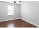 Bedroom features hardwood flooring, a window, and neutral walls at 7725 Tangle Rush Dr, Gibsonton, FL 33534