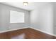 A bright bedroom features hardwood floors and a window at 7725 Tangle Rush Dr, Gibsonton, FL 33534