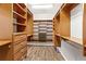 Spacious walk-in closet with custom wood shelving and drawers providing ample storage at 7725 Tangle Rush Dr, Gibsonton, FL 33534