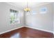 Bright dining room featuring hardwood floors, ample natural light and elegant chandelier at 7725 Tangle Rush Dr, Gibsonton, FL 33534