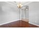 Spacious dining room with hardwood floors and an elegant chandelier at 7725 Tangle Rush Dr, Gibsonton, FL 33534