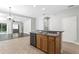 Open kitchen with stainless steel dishwasher and a large island overlooking the living area at 7725 Tangle Rush Dr, Gibsonton, FL 33534