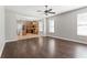 Open-concept living room with hardwood floors flowing into an adjacent kitchen at 7725 Tangle Rush Dr, Gibsonton, FL 33534