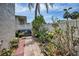 Charming backyard featuring pavers, lush landscaping, a bench, and a private fence at 920 Virginia St # 109, Dunedin, FL 34698