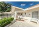 Inviting clubhouse exterior featuring a well-maintained facade, bench, and manicured landscaping at 920 Virginia St # 109, Dunedin, FL 34698