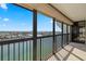 Spacious balcony with black railings offering panoramic views of the city and water at 9415 Blind Pass Rd # 1201, St Pete Beach, FL 33706