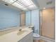 Bright blue bathroom with a frosted glass shower at 9415 Blind Pass Rd # 1201, St Pete Beach, FL 33706