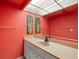 Bathroom features a large mirror over vanity, complemented by tasteful botanical art at 9415 Blind Pass Rd # 1201, St Pete Beach, FL 33706