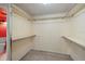 Walk-in closet with simple shelving and carpet floors at 9415 Blind Pass Rd # 1201, St Pete Beach, FL 33706