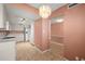 Open kitchen with pink walls, tile flooring, and a dining area at 9415 Blind Pass Rd # 1201, St Pete Beach, FL 33706