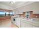 Well-equipped kitchen with modern appliances and a dining area overlooking the city at 9415 Blind Pass Rd # 1201, St Pete Beach, FL 33706