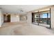Open living space featuring mirrors, chandelier, and a balcony with scenic views at 9415 Blind Pass Rd # 1201, St Pete Beach, FL 33706