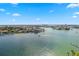 Wonderful aerial view of the waterfront with a boat sailing down the waterway and blue skies at 9415 Blind Pass Rd # 1201, St Pete Beach, FL 33706