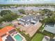 New two-story home featuring a dark roof, white exterior, and backyard overlooking the waterfront at 944 31St Ne Ter, St Petersburg, FL 33704