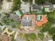 Aerial view showcases a property with a spacious lot, outlined in red, in a neighborhood with pools at 944 31St Ne Ter, St Petersburg, FL 33704