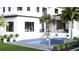 A modern home backyard featuring a pool, spa, outdoor seating, and lush landscaping in a tropical setting at 944 31St Ne Ter, St Petersburg, FL 33704