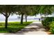 Scenic beach view with volleyball nets and walking path shaded by lush trees at 944 31St Ne Ter, St Petersburg, FL 33704