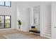 Light-filled foyer with high ceilings, a modern bench with pillows, wood floors, and a staircase leading to the upper level at 944 31St Ne Ter, St Petersburg, FL 33704
