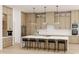 Elegant kitchen featuring custom wood cabinetry, a large center island with seating, and stainless steel appliances at 944 31St Ne Ter, St Petersburg, FL 33704