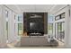 Bright and airy living room with a modern fireplace, floor-to-ceiling windows, and comfortable seating area at 944 31St Ne Ter, St Petersburg, FL 33704