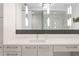 Contemporary bathroom with dual sinks, modern lighting, and walk-in shower at 100 1St N Ave # 2207, St Petersburg, FL 33701