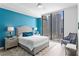 Comfortable bedroom featuring blue accent wall and cityscape views at 100 1St N Ave # 2207, St Petersburg, FL 33701