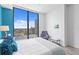 Bedroom boasts floor-to-ceiling windows, offering views of the city skyline at 100 1St N Ave # 2207, St Petersburg, FL 33701