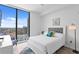 Bright bedroom with white walls, modern furniture, and a large window with city views at 100 1St N Ave # 2207, St Petersburg, FL 33701