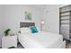 Comfortable bedroom with white walls, white bed, soft lighting, and a decorative painting at 100 1St N Ave # 2207, St Petersburg, FL 33701