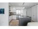 Modern kitchen with a center island, stainless steel appliances, and sleek white cabinetry at 100 1St N Ave # 2207, St Petersburg, FL 33701