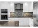 Modern kitchen featuring built-in stainless steel oven and microwave and stylish mosaic backsplash at 100 1St N Ave # 2207, St Petersburg, FL 33701