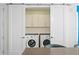 Convenient laundry area with a side-by-side washer and dryer and built-in storage cabinets at 100 1St N Ave # 2207, St Petersburg, FL 33701