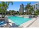 Inviting outdoor pool area surrounded by lush landscaping, lounge chairs, and clear blue water at 100 1St N Ave # 2207, St Petersburg, FL 33701