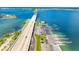 Wide aerial shot of a bridge, boat ramp, and parking area along the waterfront, with clear blue skies at 100 Bluff View Dr # 404C, Belleair Bluffs, FL 33770