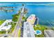 An aerial view of the building features a waterfront location and nearby bridge access at 100 Bluff View Dr # 404C, Belleair Bluffs, FL 33770