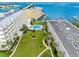 An aerial perspective showcases a swimming pool surrounded by lush greenery and waterfront access, a luxurious community feel at 100 Bluff View Dr # 404C, Belleair Bluffs, FL 33770