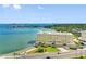 Waterfront condo building offering bay access, beach, lush landscaping, and convenient parking spots at 100 Bluff View Dr # 404C, Belleair Bluffs, FL 33770