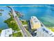 Aerial view showcases the building's location along the coastline, close to the bridge at 100 Bluff View Dr # 404C, Belleair Bluffs, FL 33770
