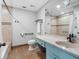 Bathroom with blue vanity features a bathtub with updated hardware and tiled floors at 100 Bluff View Dr # 404C, Belleair Bluffs, FL 33770