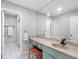 Well-lit bathroom featuring decorative vanity, mirror, and walk-in shower at 100 Bluff View Dr # 404C, Belleair Bluffs, FL 33770