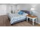 Bright bedroom featuring a bed with stylish blue patterned bedding and nautical decor at 100 Bluff View Dr # 404C, Belleair Bluffs, FL 33770
