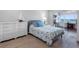 Well-lit bedroom featuring nautical decor and a sliding glass door with view to water at 100 Bluff View Dr # 404C, Belleair Bluffs, FL 33770