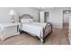Bedroom with a closet and a wooden bed frame with a white comforter and matching side table at 100 Bluff View Dr # 404C, Belleair Bluffs, FL 33770