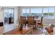 Charming dining room featuring a wooden table with woven chairs and a beautiful waterfront view at 100 Bluff View Dr # 404C, Belleair Bluffs, FL 33770
