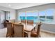 Bright dining room with scenic waterfront view, featuring a charming table and six chairs at 100 Bluff View Dr # 404C, Belleair Bluffs, FL 33770